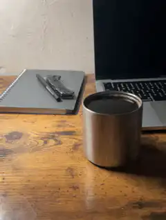 Coffee cup on desk with laptop
