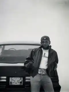 Tupac Shakur waving by a car