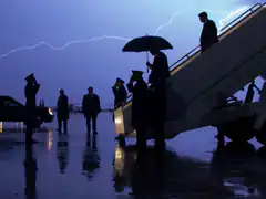 silhouetted figures on tarmac with lightning