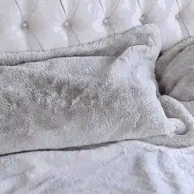 woman falling back onto bed laughing