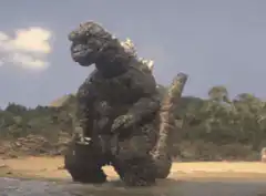 Godzilla dancing on the beach
