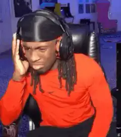 Man in orange shirt listening to music with headphones