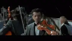 Violinist playing on sinking ship deck
