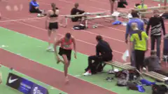 Athlete running barefoot and landing in sand pit