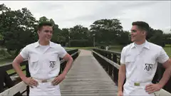 Two men in white shirts high five and thumbs up