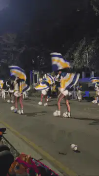 cheerleaders marching with pom-poms