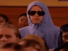 Woman in blue hoodie and sunglasses