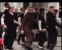 Arab man dancing with a group