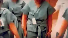 Healthcare workers dancing in scrubs and PPE