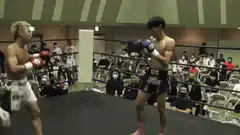 Boxer knocks down opponent with a kick