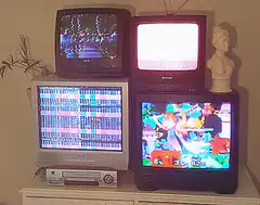 Four TVs showing different channels