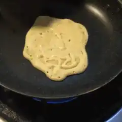 Pancake with face drawn in batter