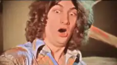 Man with curly hair and wide eyes