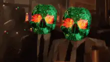 Two green skulls with orange eyes
