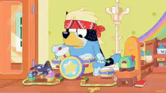 Bluey playing drums blindfolded