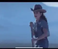 Young girl and man in cowboy hats