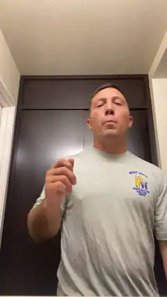 Man in grey shirt pointing finger