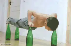 Man doing pushups on green bottles