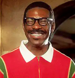 Eddie Murphy laughing in red sweater