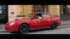 Tom Cruise in red car talking on phone