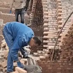 Bricklayer laying bricks with trowel