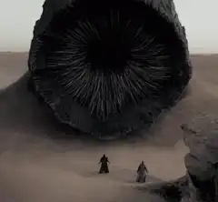 Two figures face a giant eye in the desert