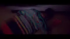 man in sweater lying on floor with red cup