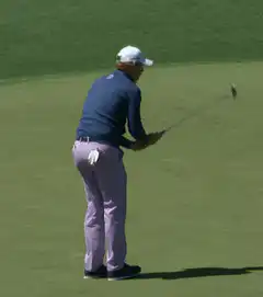 golfer misses putt and reacts