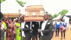 Ghanaian pallbearers dancing with coffin