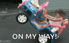 Toddler in toy car on two wheels