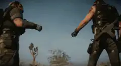 Two soldiers fist bump in desert