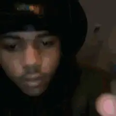 man aims laser sight gun at camera