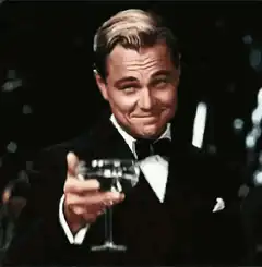 Leonardo DiCaprio toasting with a drink