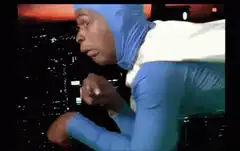 Man in blue suit flying over city