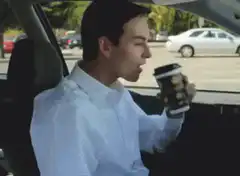 Man spills coffee in car