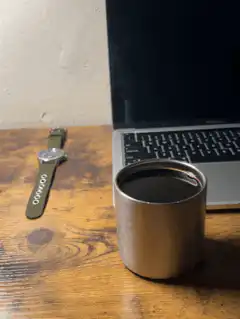 coffee cup on desk with laptop