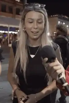 Girl points at camera then laughs