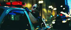 Joker laughing in police car