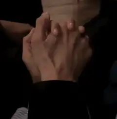 Two hands clasped together