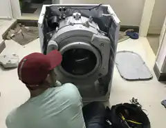 man fixing washing machine