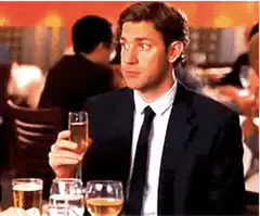 Jim Halpert raises glass and smirks