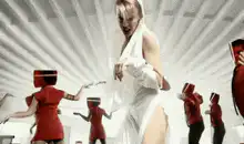 Madonna in white with red masked dancers