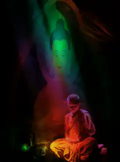 monk meditating under rainbow light
