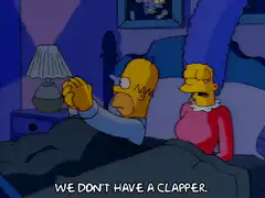 Homer and Marge in bed clapping