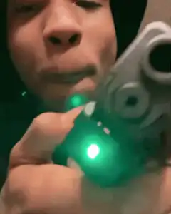 Man aims gun with green laser