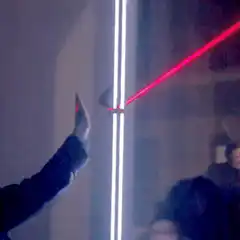 Person dodging a red laser beam