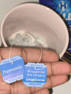 Peppermint tea tag held over mug