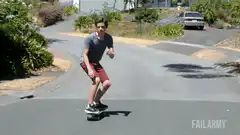 skateboarder falls on downhill road
