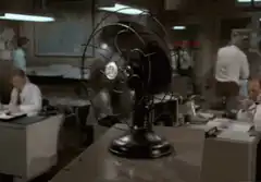Office fan spinning in background