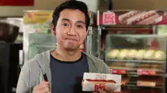 Man shrugs with hot dog Wala Eh